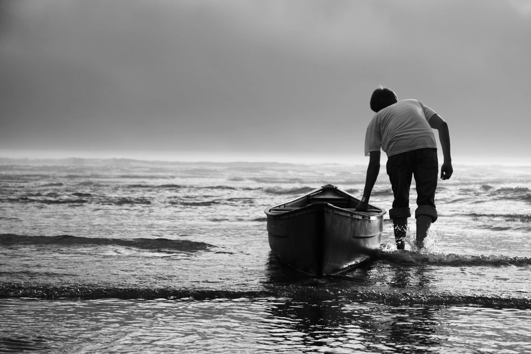 Man Pulling Canoe into Water, Black and White